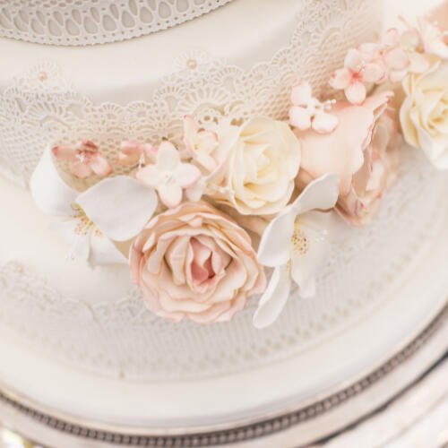 a mini sword stuck in a field of clovers with two rings hanging off it