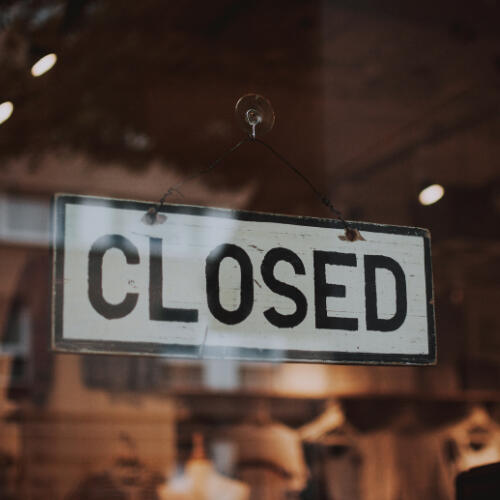 black and white hanging 'closed' sign