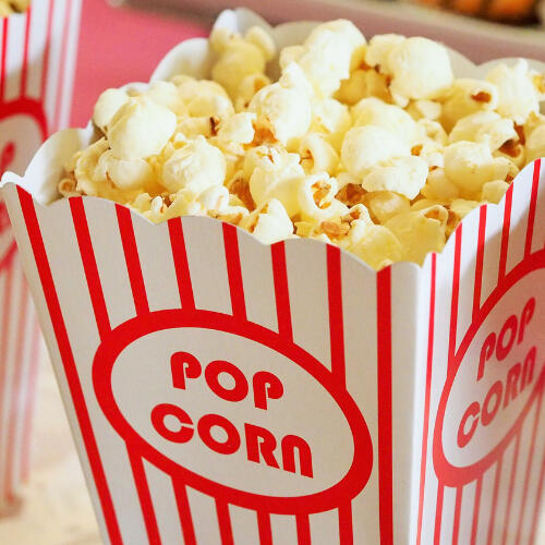 red and white container of popcorn