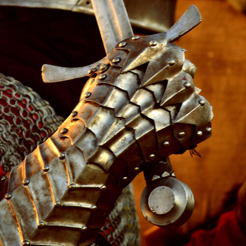 a gauntleted hand holding a sword