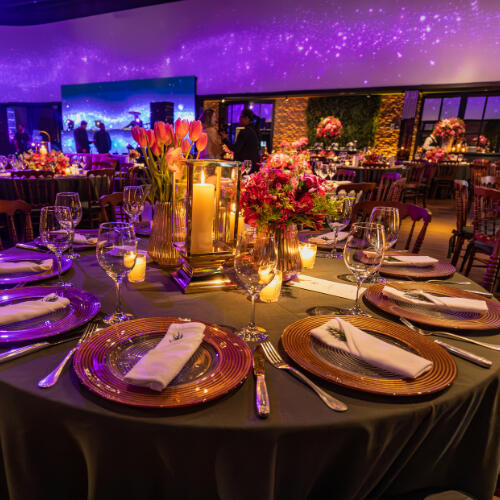 a table set at a gala a gauntleted hand holding a sword