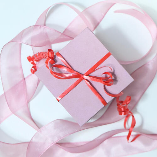a pink box wrapped in pink ribbons